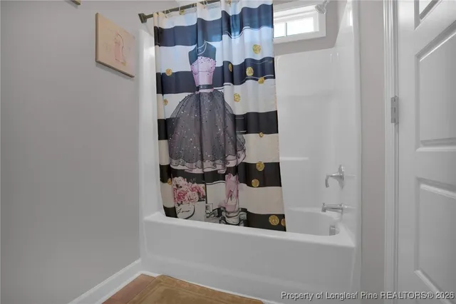 a bathroom with a bathtub and shower