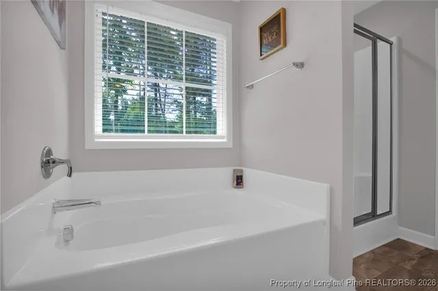 a white bath tub sitting next to a window