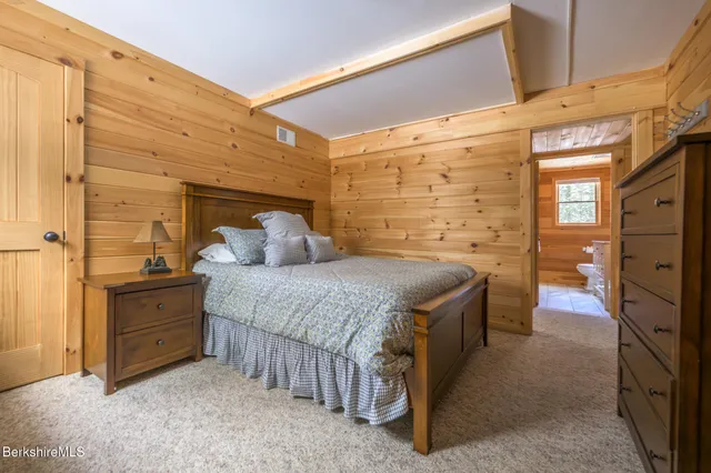 a bathroom with a granite countertop toilet sink and mirror