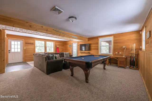 a kitchen with stainless steel appliances granite countertop a stove top oven a sink dishwasher and wooden cabinets with large window