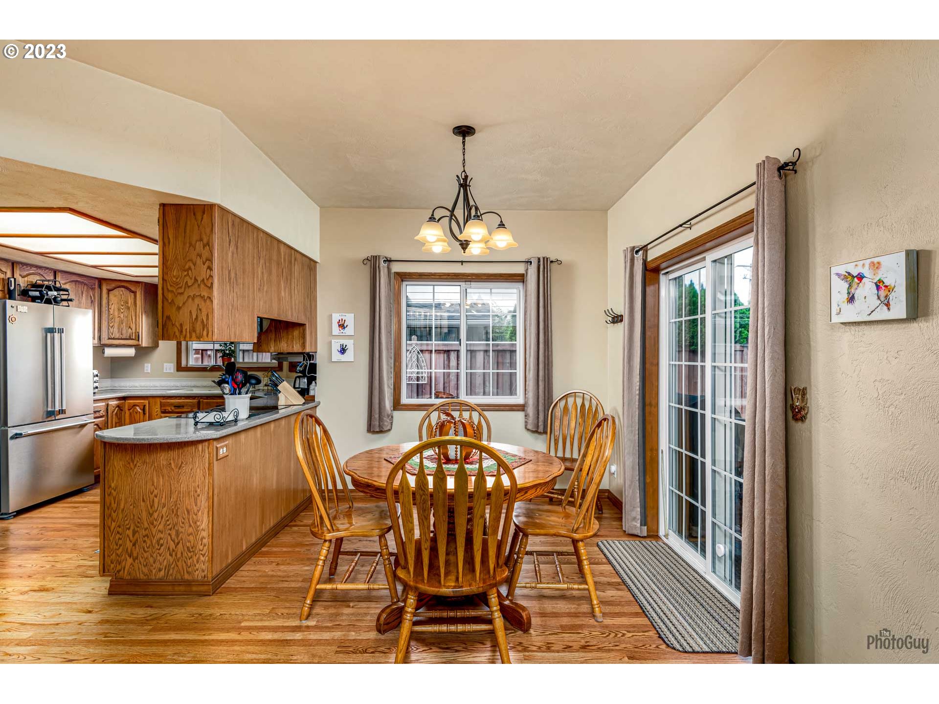 551 68th Place Springfield, OR 97478 - Photo 13 of 45 a dining room with furniture a chandelier and window