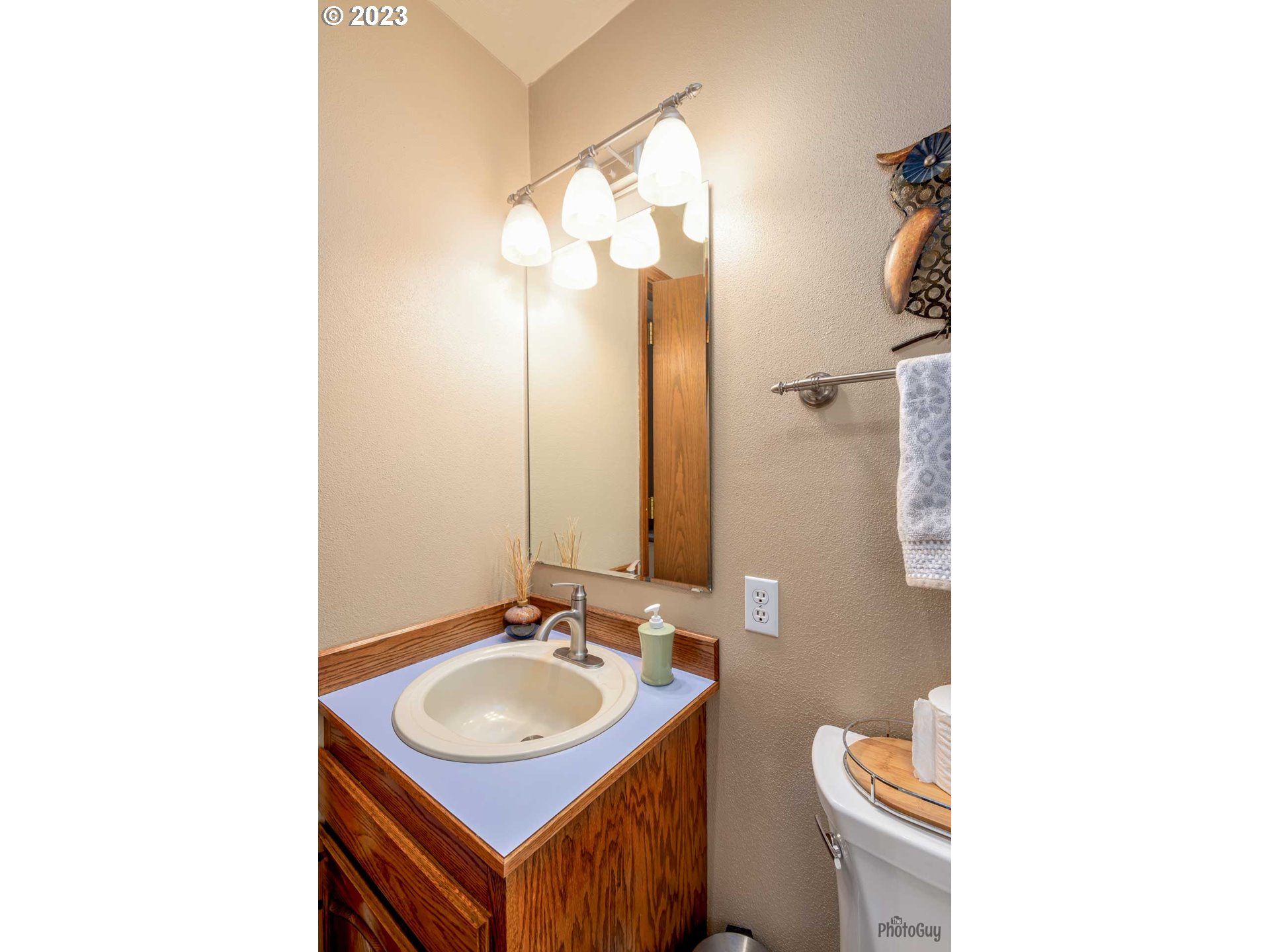 551 68th Place Springfield, OR 97478 - Photo 33 of 45 a bathroom with a sink toilet a mirror and vanity