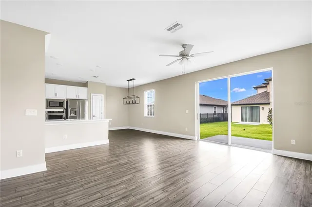 a view of a livingroom with a furniture wooden floor and window
