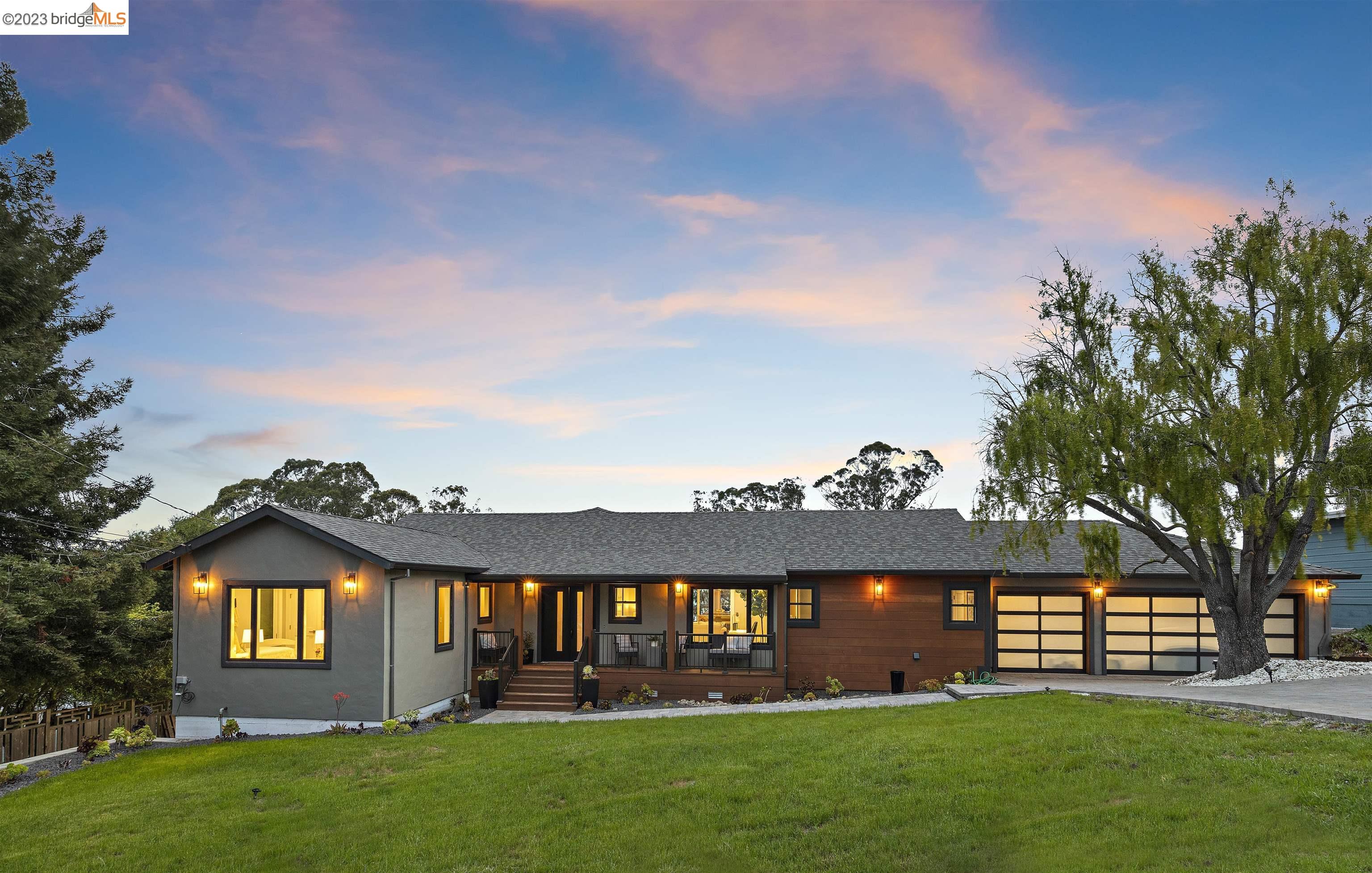 a view of a big yard with large trees and plants
