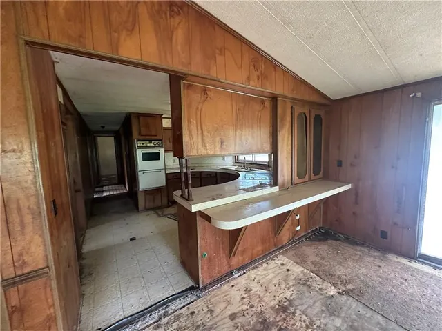 a kitchen with stainless steel appliances granite countertop a sink and a refrigerator