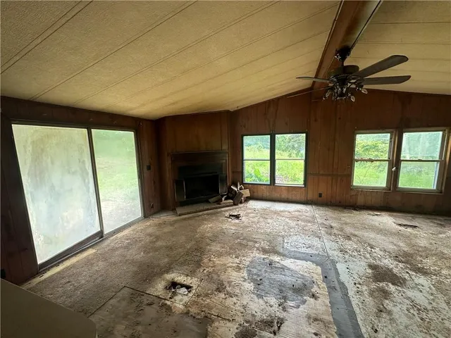 a view of empty room with a fireplace