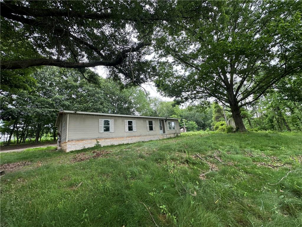 22 Howes Lane Fredericktown, PA 15333 - Photo 4 of 30 a backyard of a house with large trees and plants