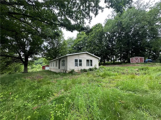 a yellow house in middle of the green field