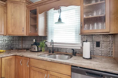 a kitchen with sink a window and cabinets