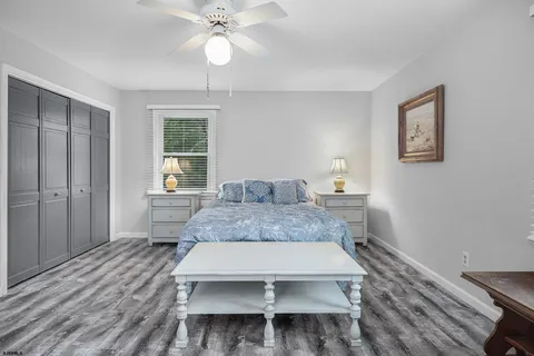 a bedroom with a large bed and a chandelier