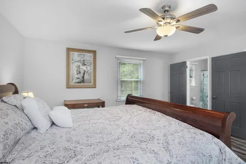 a view of a roof deck with table and chairs a barbeque with wooden floor and fence