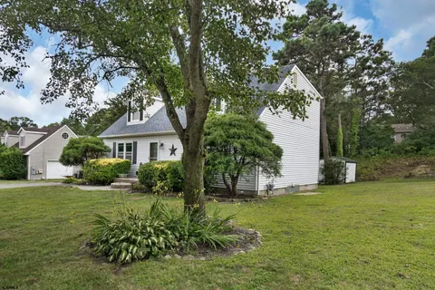 an aerial view of a house with a yard and lake view