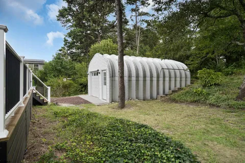 an aerial view of a house with outdoor space and lake view