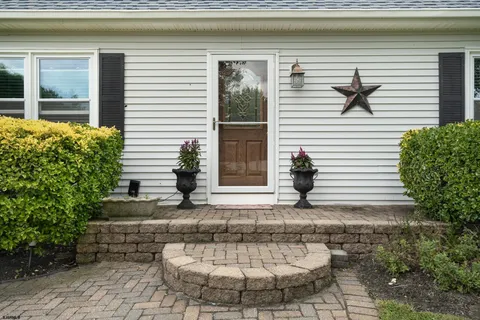 a view of a house with a chairs in patio