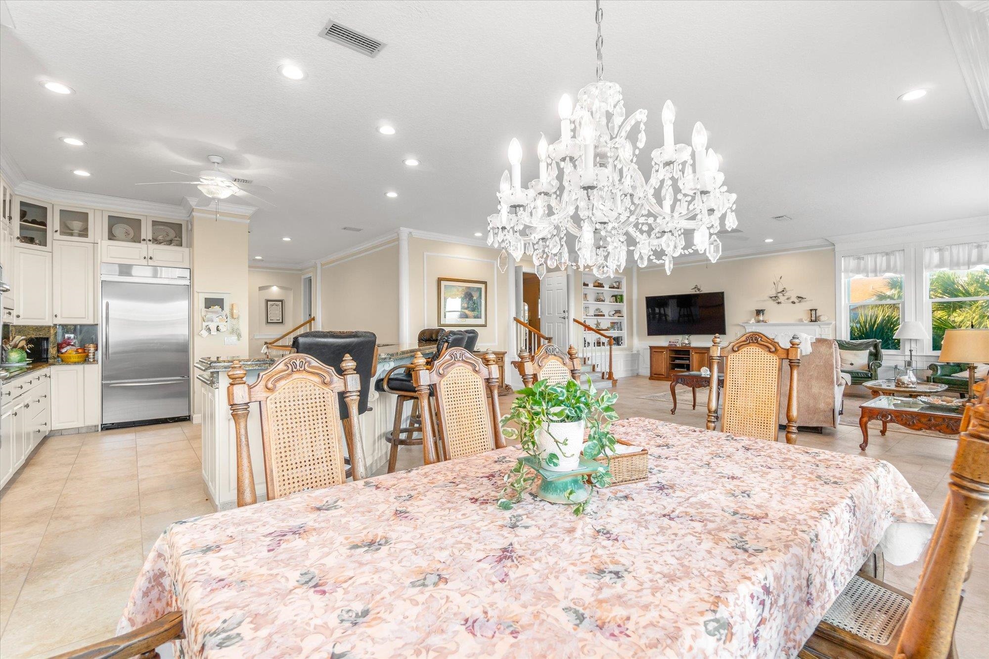 5042 Atlantic View St. Augustine, FL 32080 - Photo 11 of 72 Dining area with crown molding, stairway, light tile patterned floors, a ceiling fan, and recessed lighting