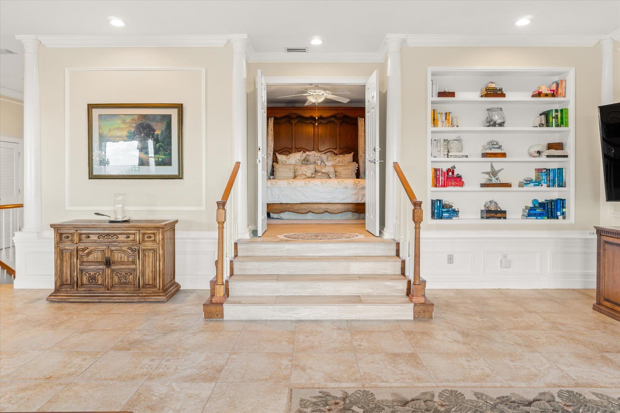 5042 Atlantic View St. Augustine, FL 32080 - Photo 15 of 72 Stairway featuring a decorative wall, wainscoting, ornamental molding, built in features, and decorative columns