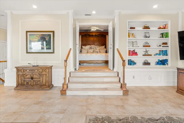 a bedroom with a large bed and a chandelier
