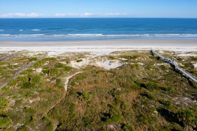 a large kitchen with granite countertop a large counter top stainless steel appliances and cabinets