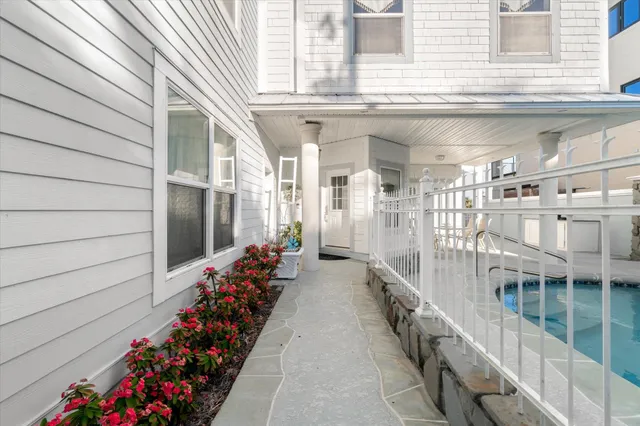 a kitchen with stainless steel appliances kitchen island granite countertop a sink a stove a dining table and chairs