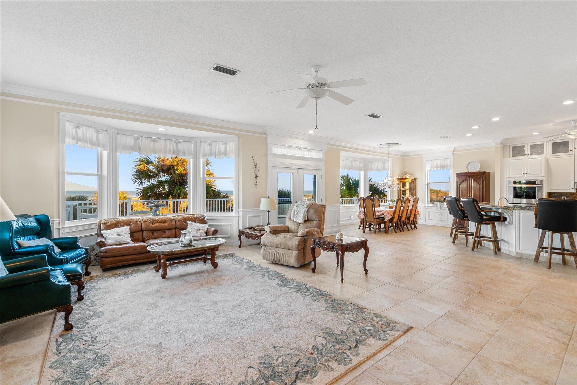 5042 Atlantic View St. Augustine, FL 32080 - Photo 6 of 72 Living area featuring ornamental molding, ceiling fan, french doors, a decorative wall, and light tile patterned floors