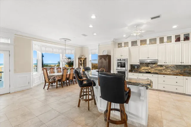 a kitchen with granite countertop a refrigerator and a stove top oven