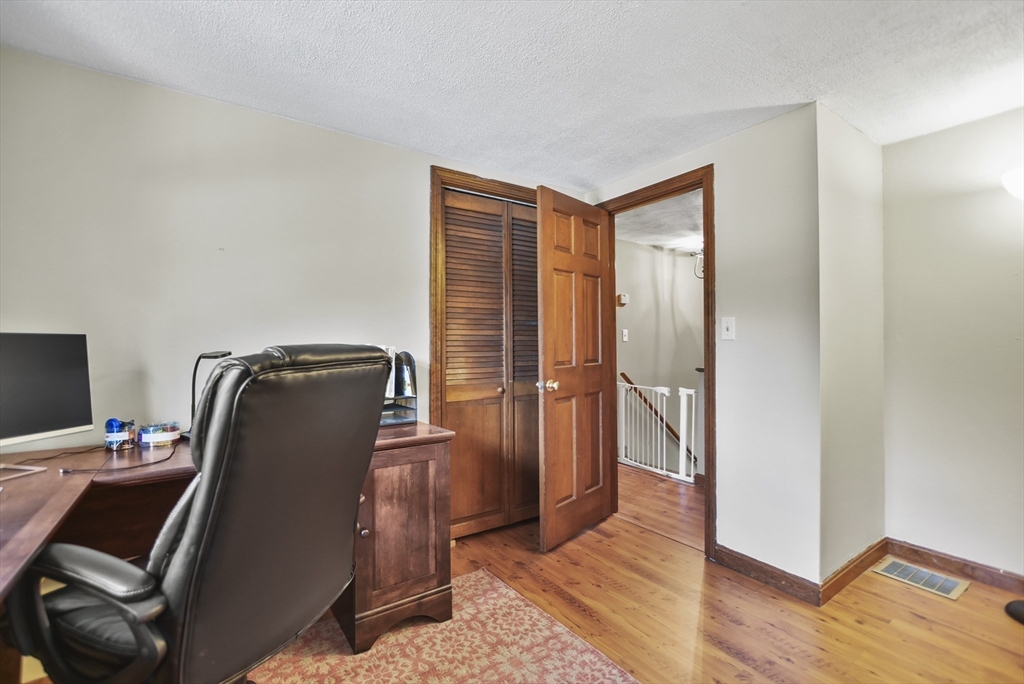 28 Adams Road Hubbardston, MA 01452 - Photo 18 of 35 a room with wooden door and furniture