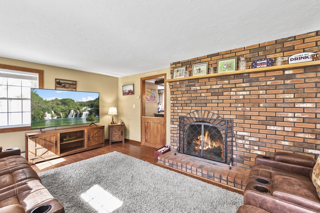 28 Adams Road Hubbardston, MA 01452 - Photo 4 of 35 a living room with furniture and a fireplace