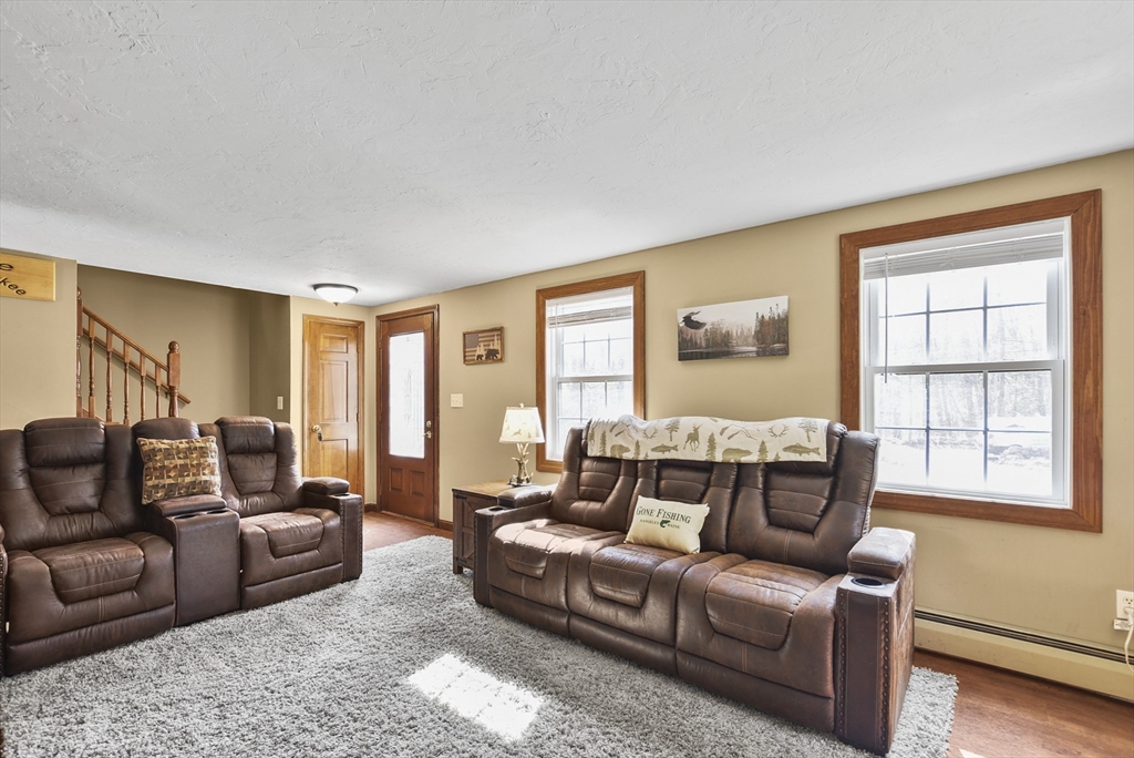 28 Adams Road Hubbardston, MA 01452 - Photo 5 of 35 a living room with furniture and a window