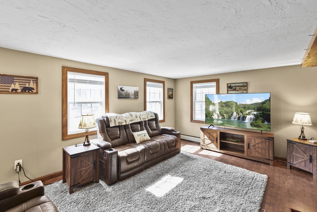 28 Adams Road Hubbardston, MA 01452 - Photo 6 of 35 a living room with furniture and a flat screen tv