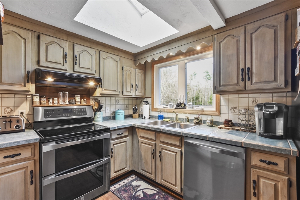 28 Adams Road Hubbardston, MA 01452 - Photo 8 of 35 a kitchen with a sink stove and cabinets