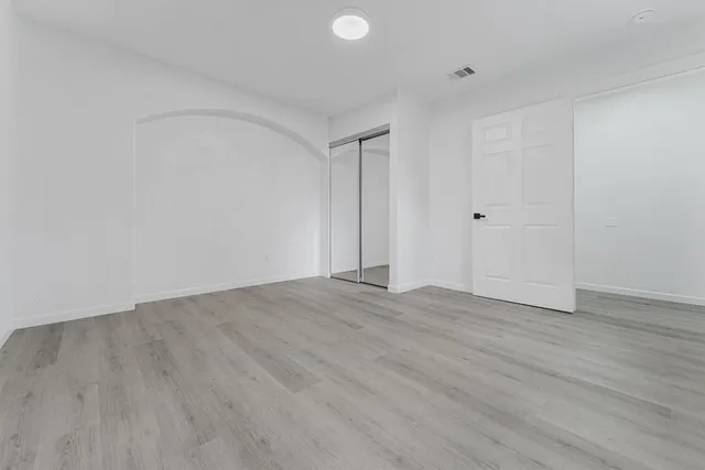 a view of a house with a backyard and a tree