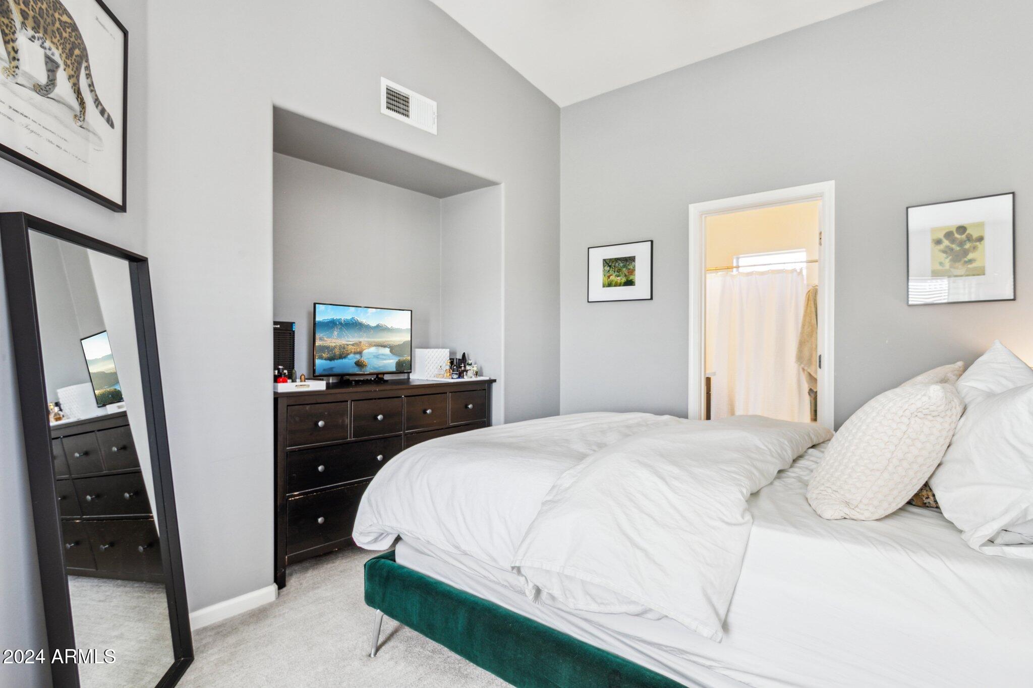 1920 East Bell Road, Unit 1161 Phoenix, AZ 85022 - Photo 15 of 37 a bedroom with a bed and a flat tv screen on dresser