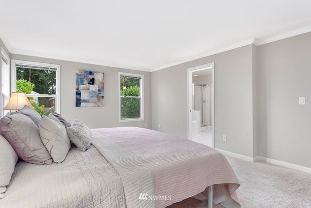 a bedroom with a large bed and a window