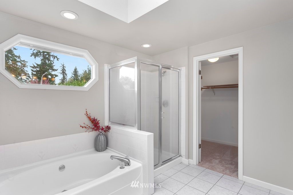 4513 Northeast 18th Street Renton, WA 98059 - Photo 15 of 25 a bathroom with a bathtub and a shower
