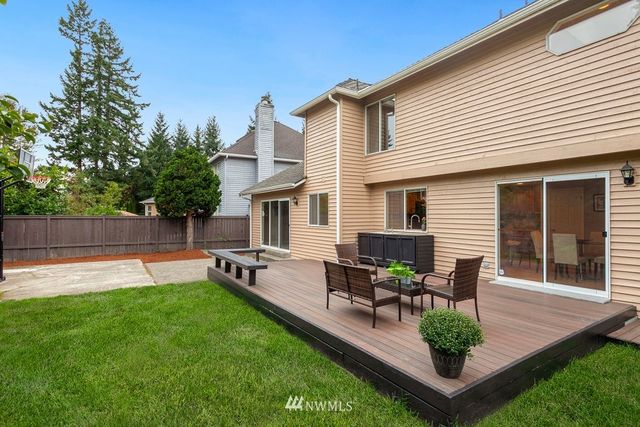 a view of house and patio with a garden