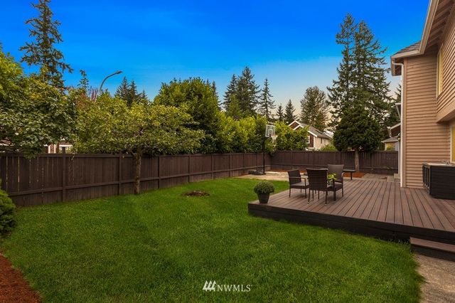 a view of a backyard with sitting area