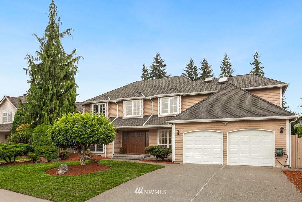 4513 Northeast 18th Street Renton, WA 98059 - Photo 25 of 25 a front view of a house with a garden and trees
