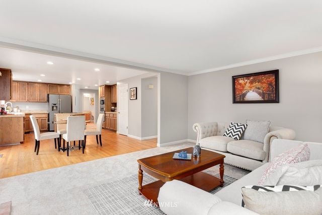 a living room with furniture kitchen view and a dining table