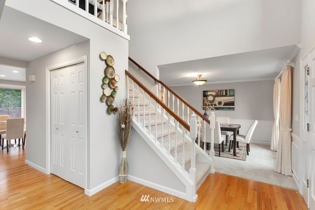 a view of entryway and hall with wooden floor