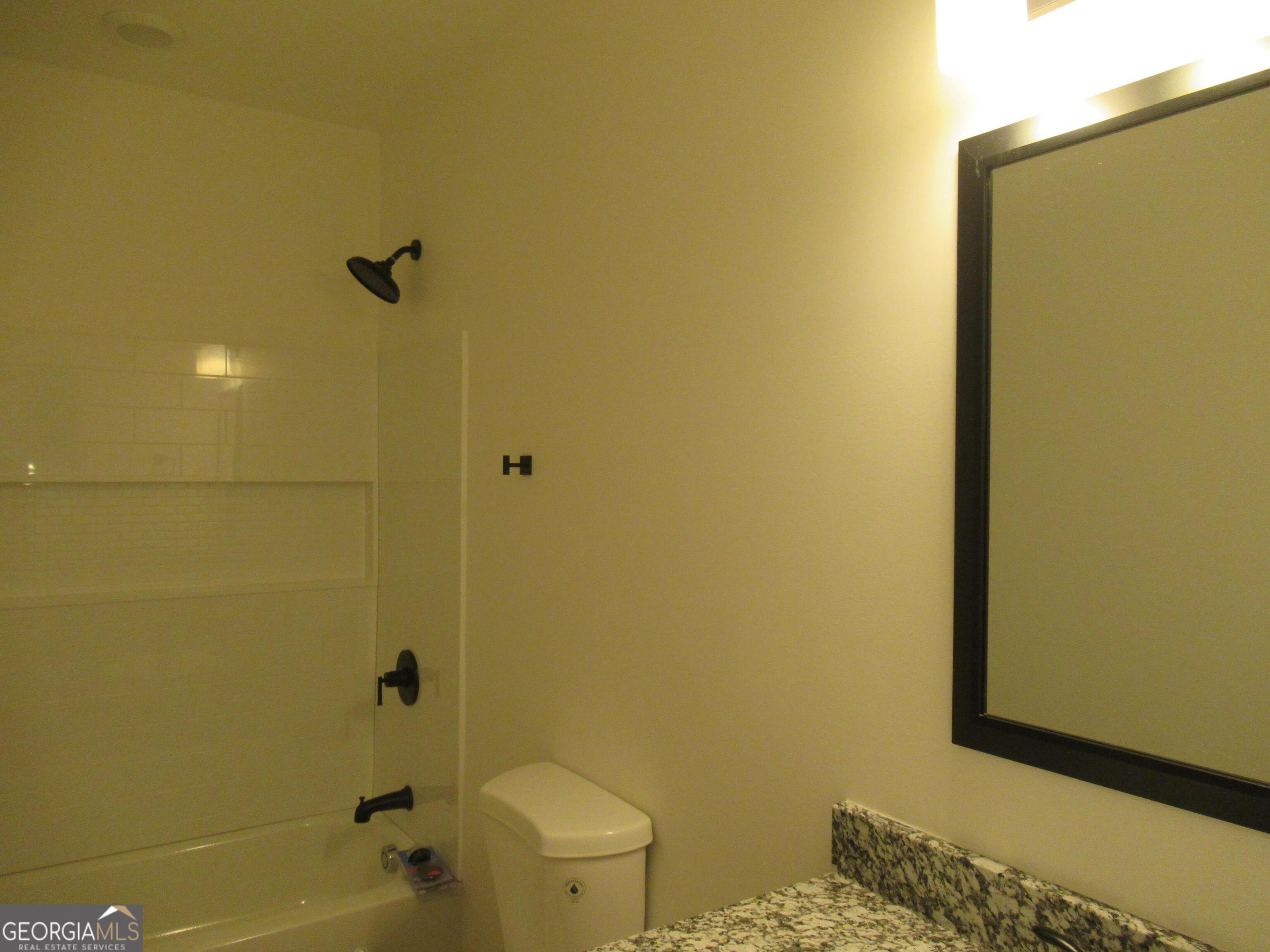 765 Old Kerns Road Dawsonville, GA 30534 - Photo 32 of 36 a bathroom with a granite countertop toilet and a sink