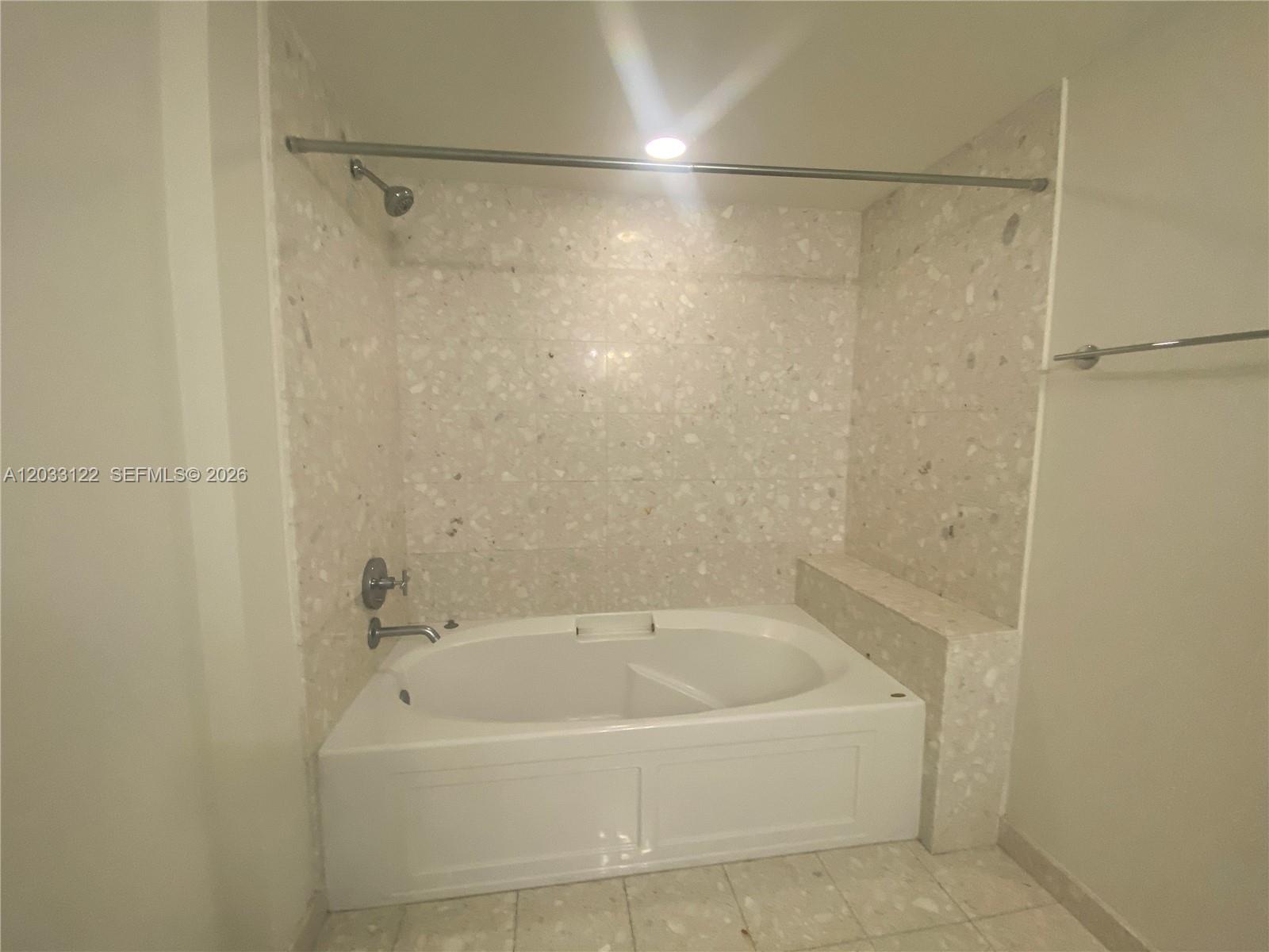 185 Southwest 7th Street, Unit 4206 Miami, FL 33130 - Photo 8 of 26 a white bath tub sitting next to a white sink and vanity