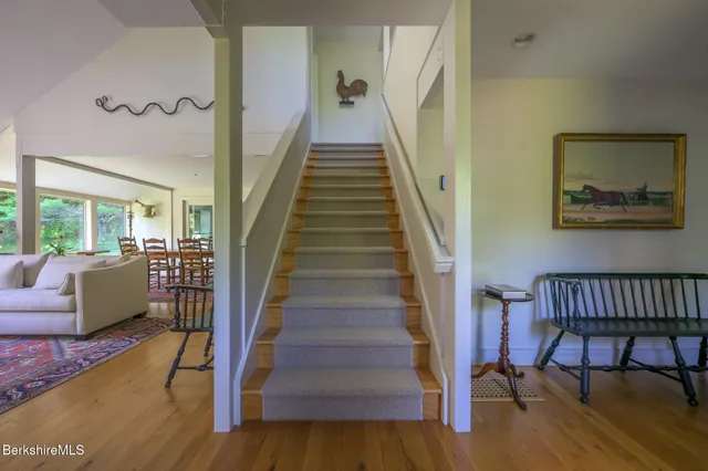 a bedroom with a bed chair and a window
