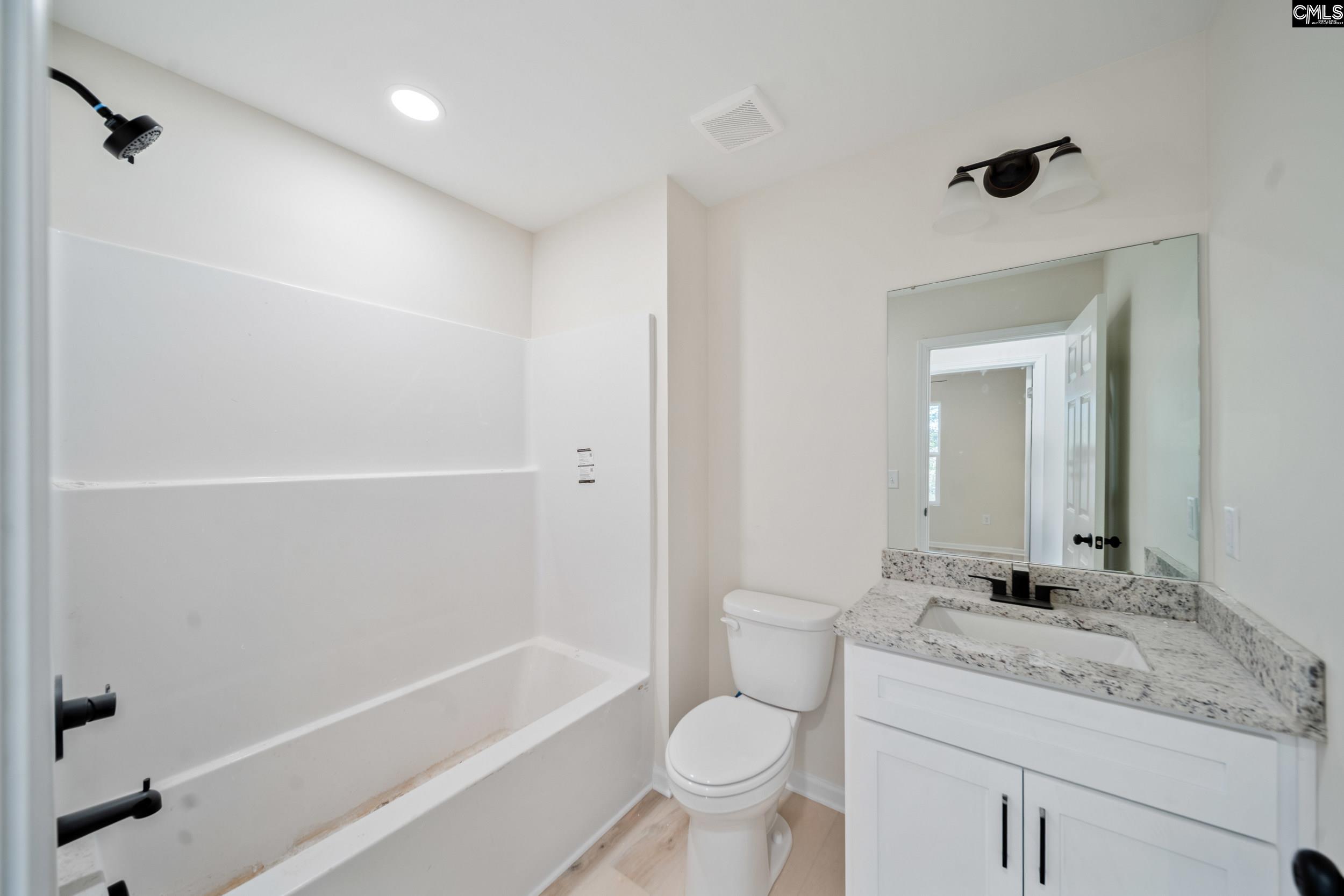 116 Sunny Acres Road Eastover, SC 29044 - Photo 13 of 40 a bathroom with a granite countertop sink toilet and shower