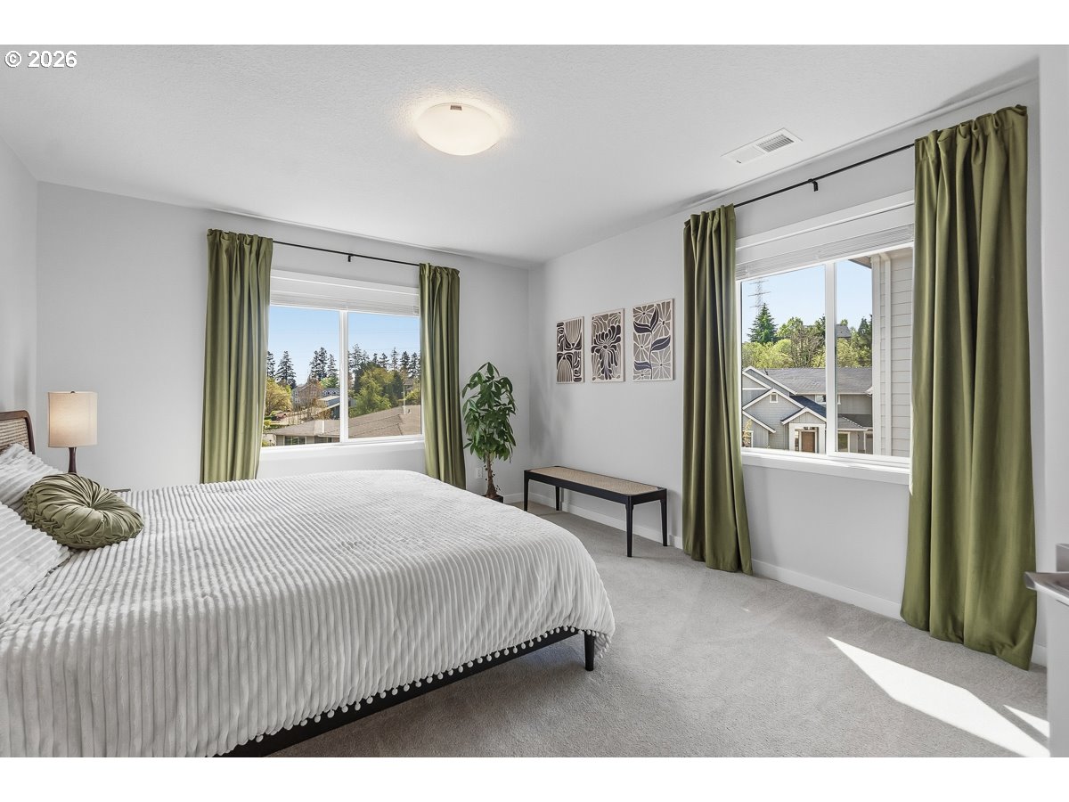 16275 Southwest Jade View Way Beaverton, OR 97007 - Photo 25 of 34 a bedroom with a large bed and a large window