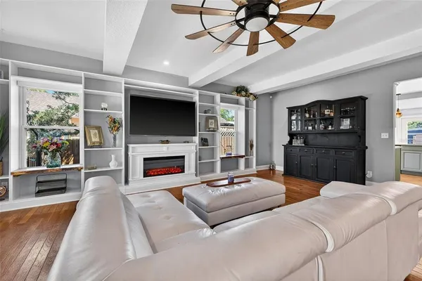 a living room with furniture a fireplace and a flat screen tv