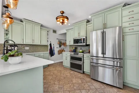 a kitchen with a refrigerator and a sink