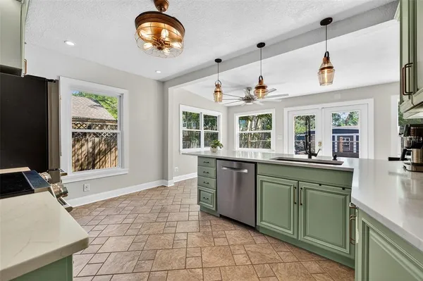 a kitchen with a sink appliances and a window
