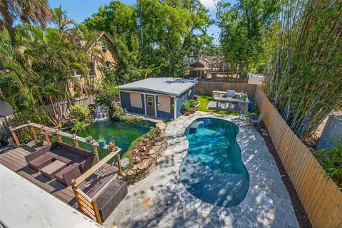 a view of a backyard with a small cabin and wooden fence