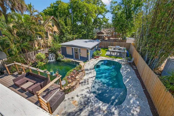 a view of a backyard with a small cabin and wooden fence