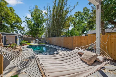 a view of a backyard with table and chairs with wooden fence